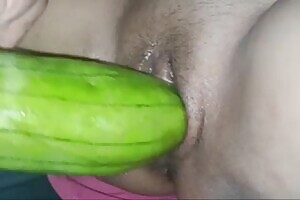 She teased her pussy hole with the gourd until she ejaculated, then stuffed it into her clitoris again. Watching it made my cock feel very excited.