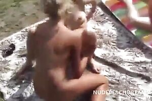 Lesbian girlfriends sharing a dick right on the beach